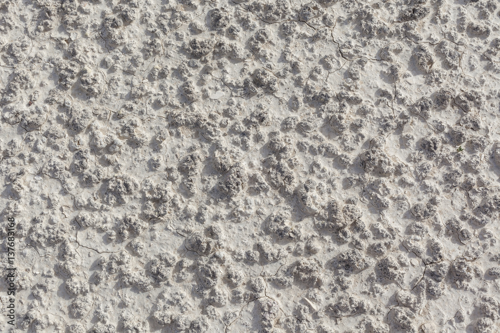 White arid cracked lumpy dry textured desert soil