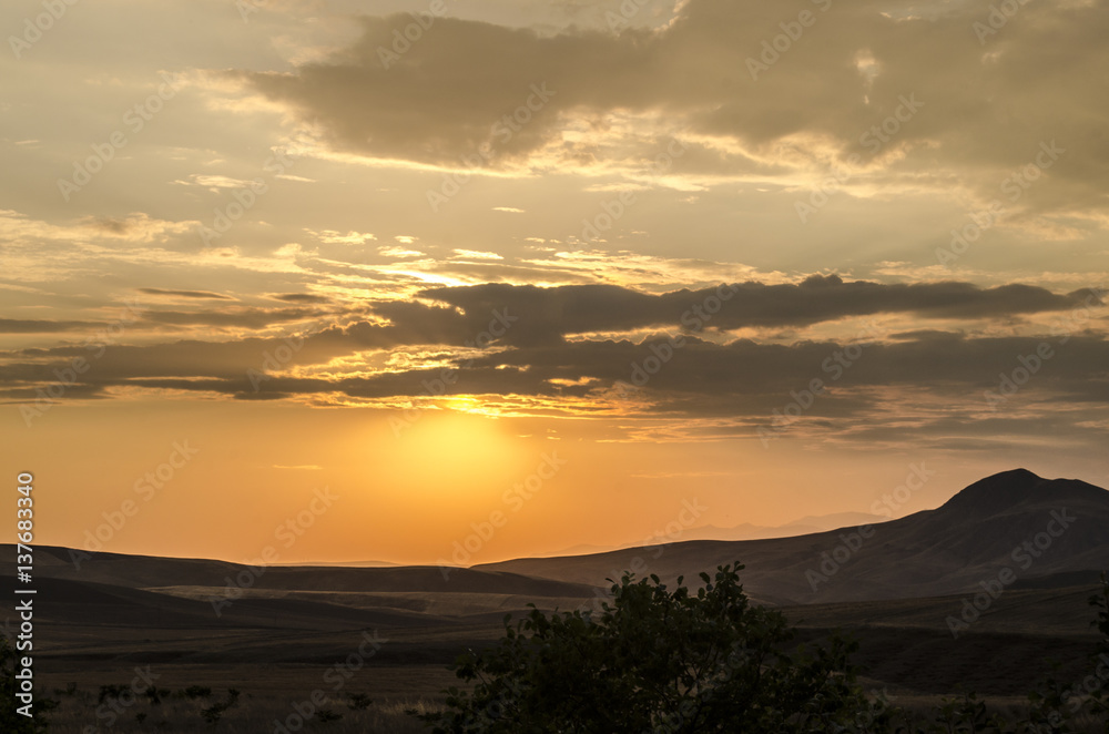 Beautiful evening view of the Azerbaijan mountains green grass meadows and hills at sunset time. Summertime