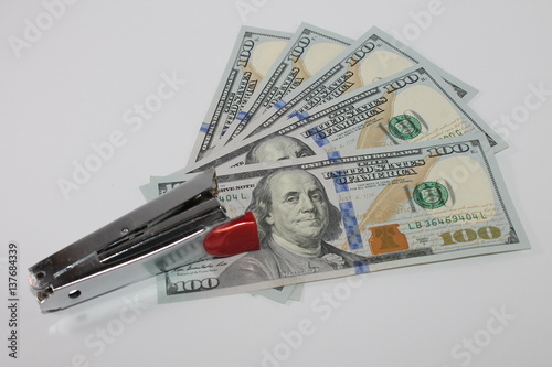 stapler and dollars
