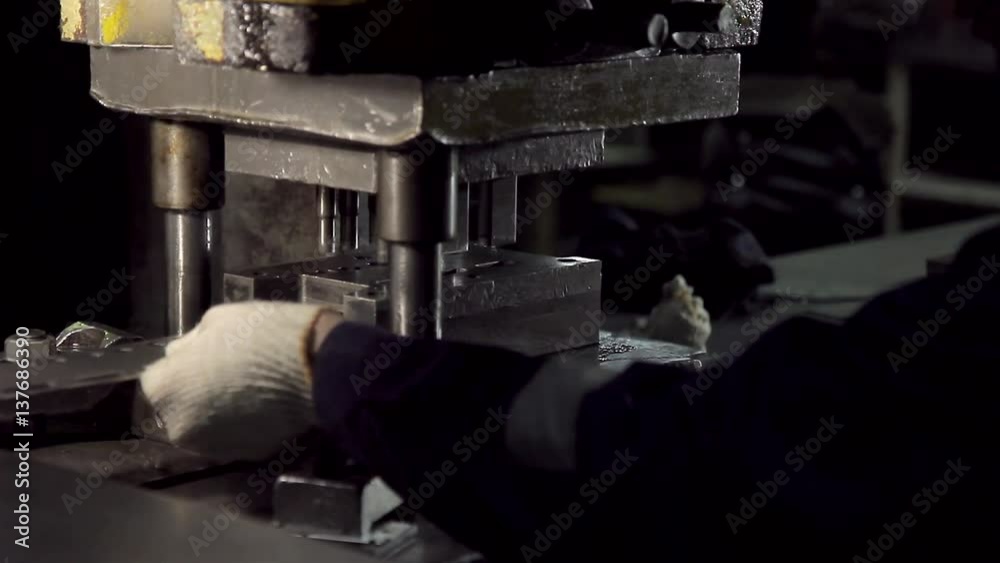 Close-up of hands working on the machine Close-up of hands working on the machine