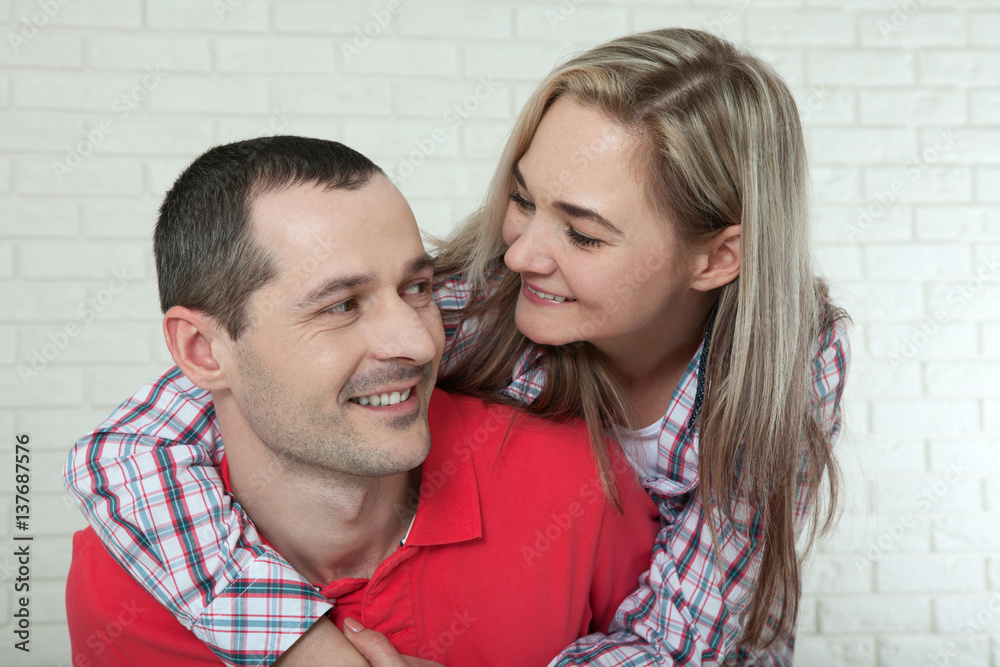 Happy young couple smiling. Man and woman hugging at home. Happy young couple smiling. Man and woman hugging at home.