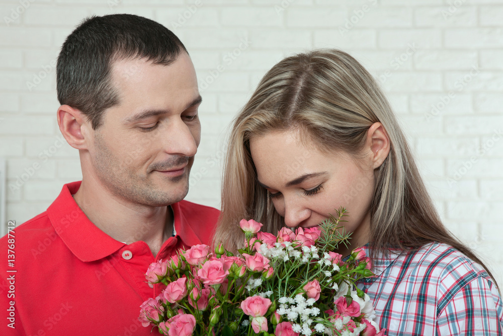 Valentine's day, anniversary, event concept - young woman receives a gift of a bouquet of flowers from her boyfriend Valentine's day, anniversary, event concept - young woman receives a gift of a bouquet of flowers from her boyfriend