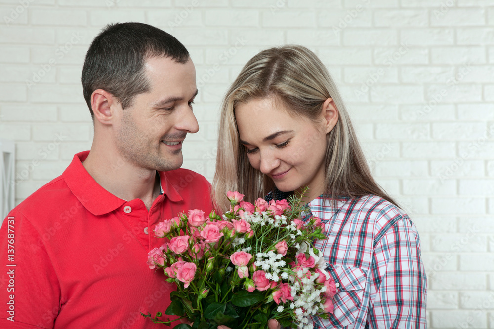 Valentine's day, anniversary, event concept - young woman receives a gift of a bouquet of flowers from her boyfriend Valentine's day, anniversary, event concept - young woman receives a gift of a bouquet of flowers from her boyfriend