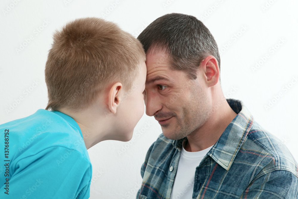 Happy father and son playing and laughing together at home. Happy father and son playing and laughing together at home.
