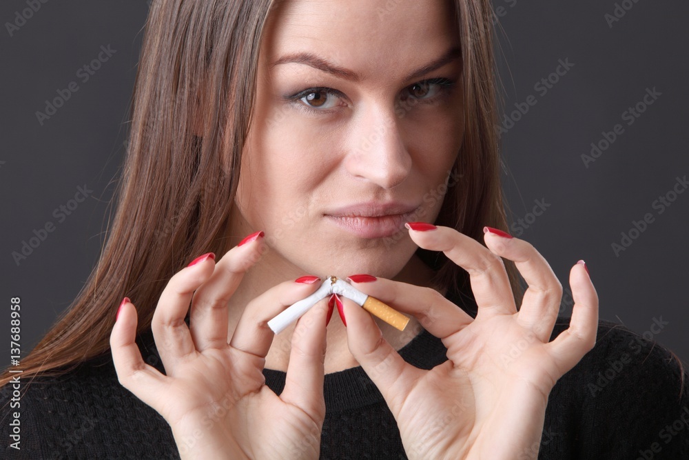 woman and stop smoking cigarette (focus on face) woman and stop smoking cigarette (focus on face)