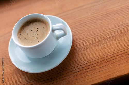 Cup of coffee on a wooden table.