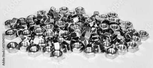 group of metal nuts isolated on white surface