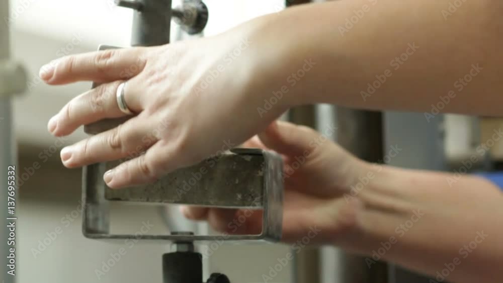 Specialist Conducts Test on Cement Strength Specialist Conducts Test on Cement Strength