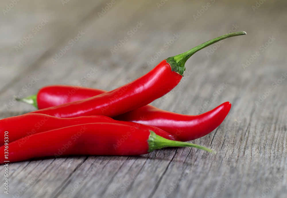 red chili peppers on wooden board, shallow depth of field, selective focus