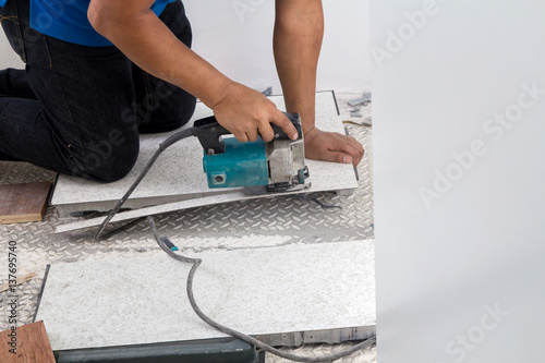 Craftsman cutting wooden plank with electric saw