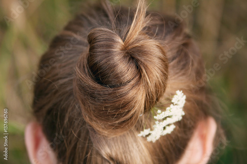 Back view of young woman with hair bun