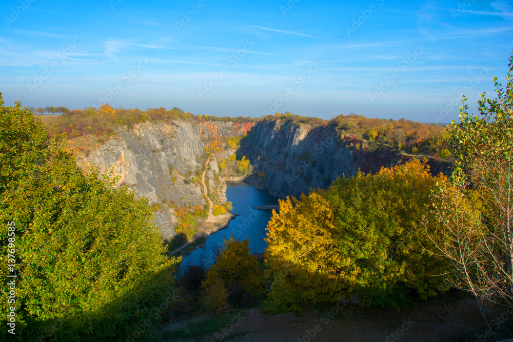 Overgrown quarry stone at sunset in autumn