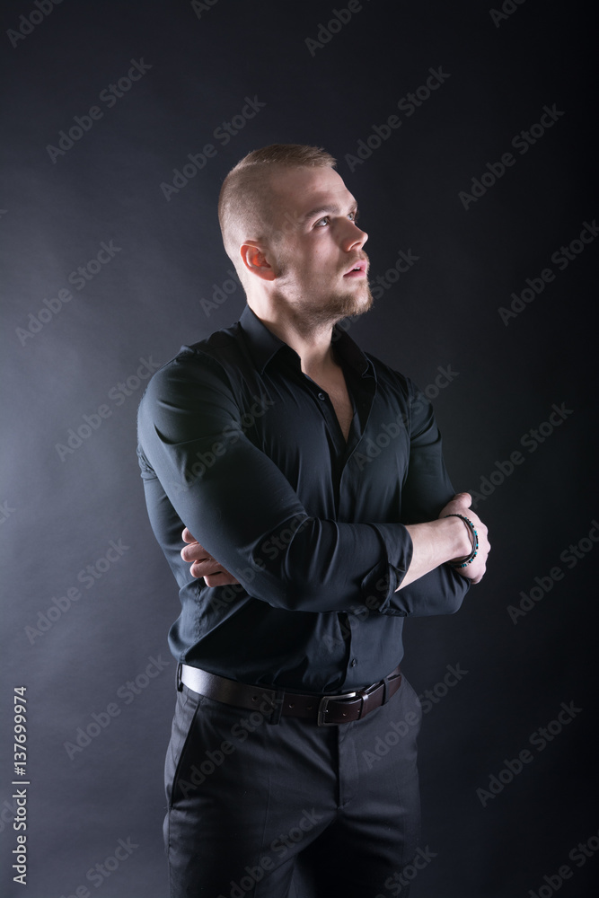 Portrait of handsome stylish man in elegant black shirt Looking in future seriously
