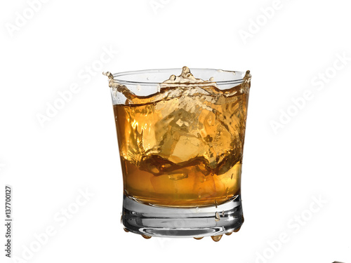 Whiskey splash in a glass isolated on white background