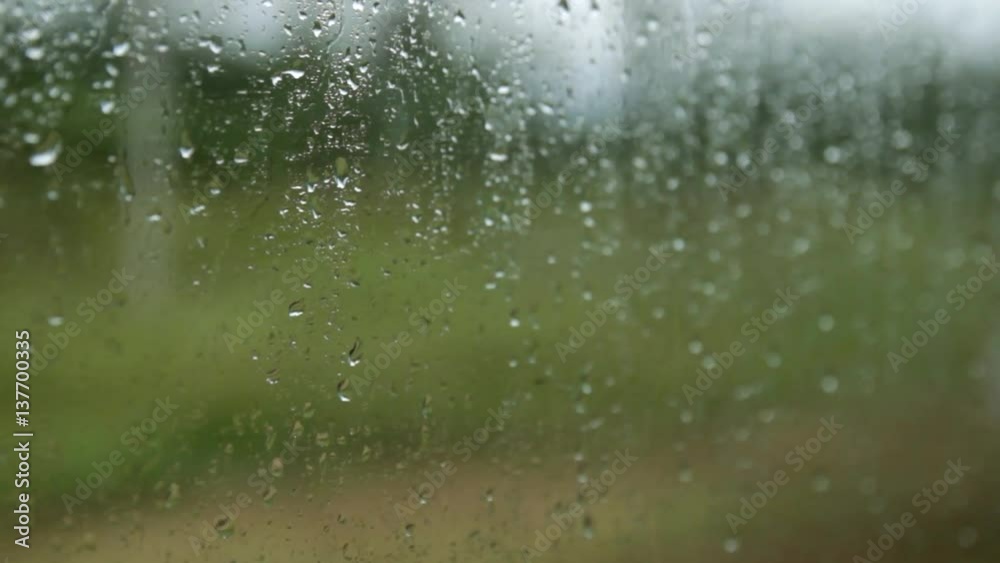 Raindrops on the train window. Blurred background outside the window. closeup Raindrops on the train window. Blurred background outside the window. closeup