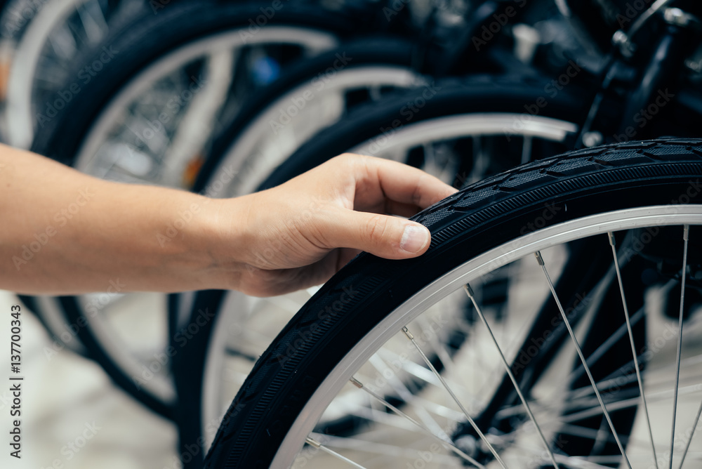 Close up on human hand checking bicycle tire