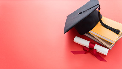 academic hat with diploma and books