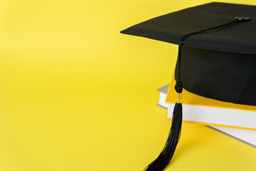academic hat with student books