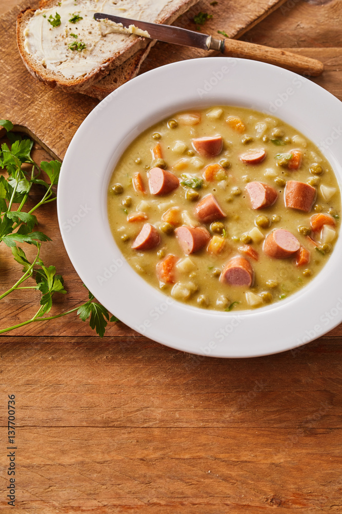 Bowl of Creamy Pea Soup with Chopped Sausage Bowl of Creamy Pea Soup with Chopped Sausage