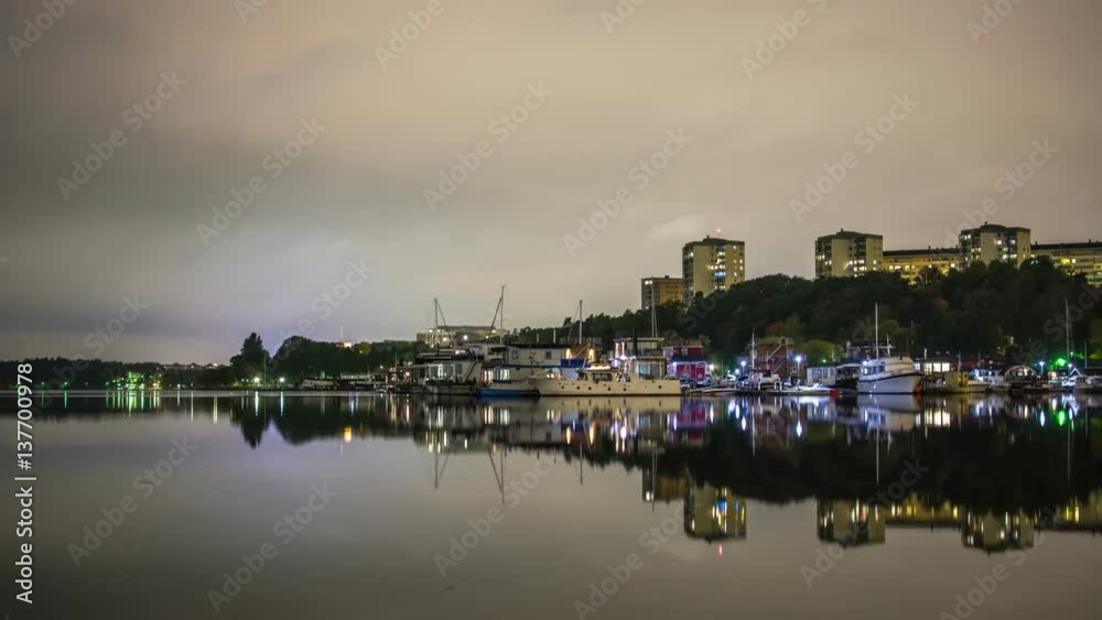 Time Lapse of boat marina at night. Calm water reflections and apartment buildings Time Lapse of boat marina at night. Calm water reflections and apartment buildings