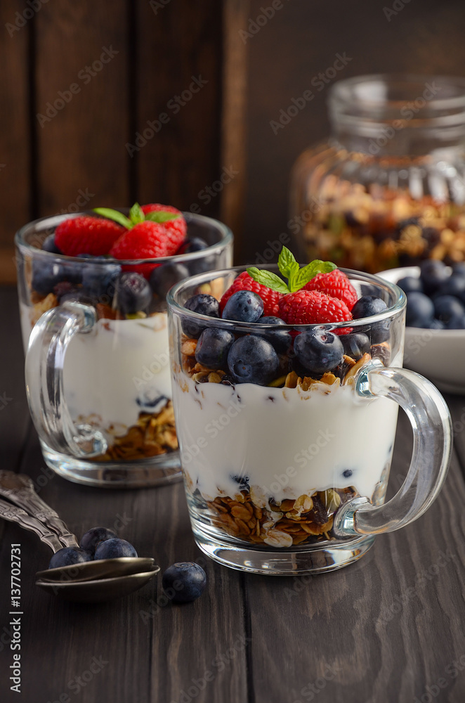 Yogurt parfait with granola and fresh berries, healthy breakfast concept, selective focus Yogurt parfait with granola and fresh berries, healthy breakfast concept, selective focus