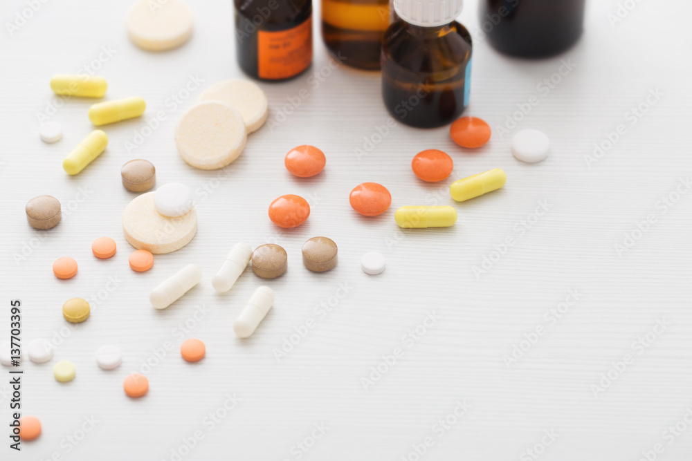 Composition of medicine bottles and pills on white background Composition of medicine bottles and pills on white background