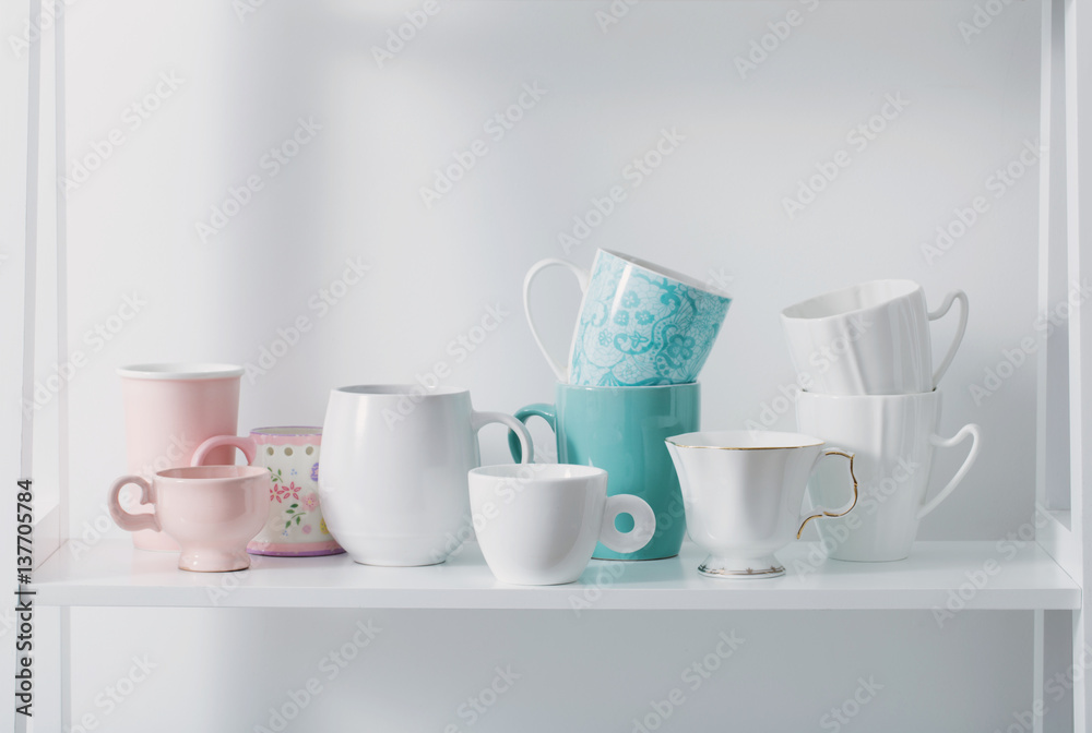 Clean dishes on white wooden shelf Clean dishes on white wooden shelf