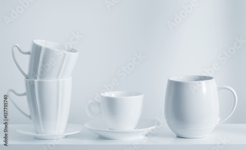 Clean cups on wooden shelf
