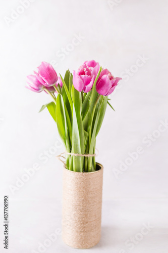 Pink tulips on a light background in handmade Vase. Pink tulip. Tulips. Flowers. Flower background. Flowers photo concept. Holidays photo concept. Copyspace