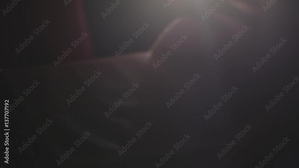 low key image of person sitting next to prayer book