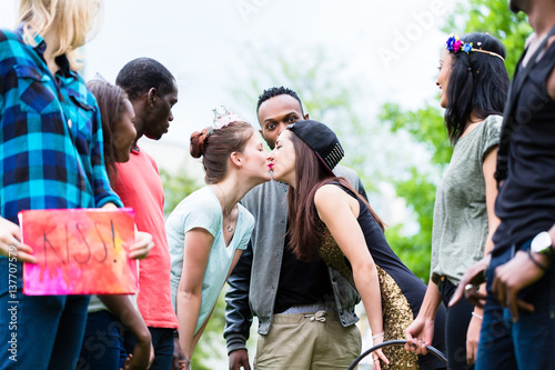 Two women kissing in party game 