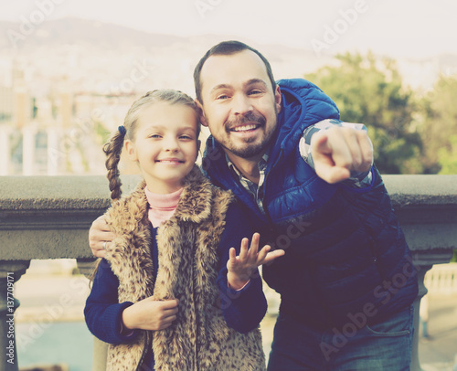 Father and daughter walking in city photo