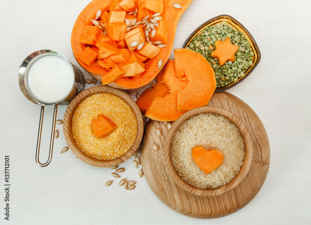Green Pea,Pieces of Pumpkin,Cereals in the Wooden Plates.Milk and Sugar.Harvest,Fresh Vegetable, Ingredient.White Background. Green Pea,Pieces of Pumpkin,Cereals in the Wooden Plates.Milk and Sugar.Harvest,Fresh Vegetable, Ingredient.White Background.