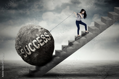 Fényképezés Businesswoman pulling success word on stair