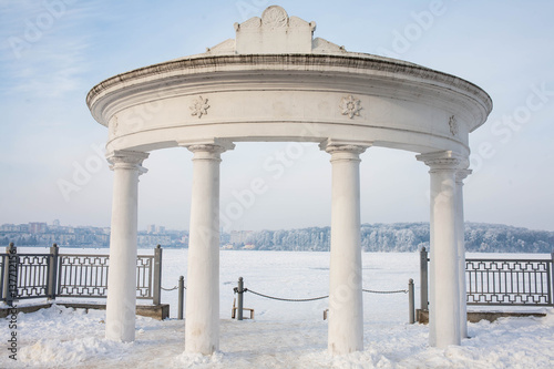 white columns in the snow in the park photo