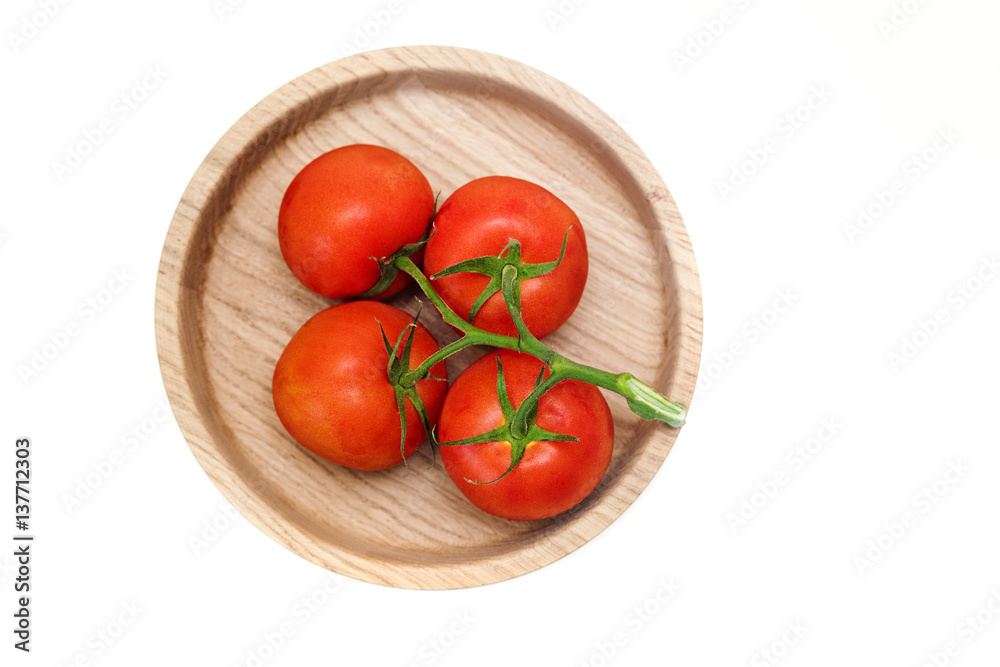 bunch of red tomatoes isolated on a white background.wooden plate.top view bunch of red tomatoes isolated on a white background.wooden plate.top view