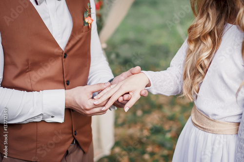 The groom wears a ring bride. Wedding ceremony.