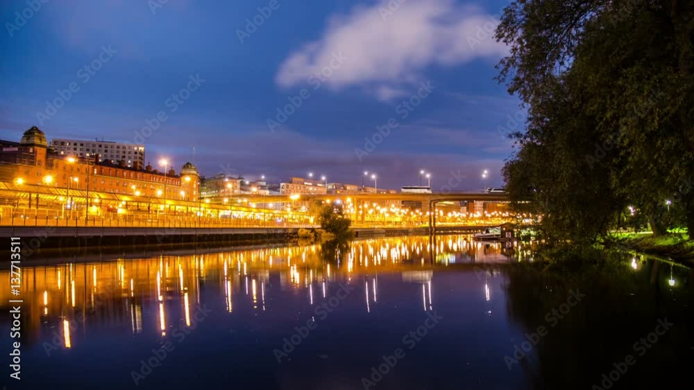 Time Lapse of river bank and illuminated railway yard at night Time Lapse of river bank and illuminated railway yard at night