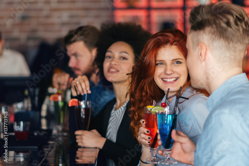 Friends drinking cocktail in bar