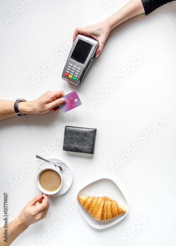 Fototapeta Naklejka Na Ścianę i Meble -  Credit card payment in cafe on white table background top view