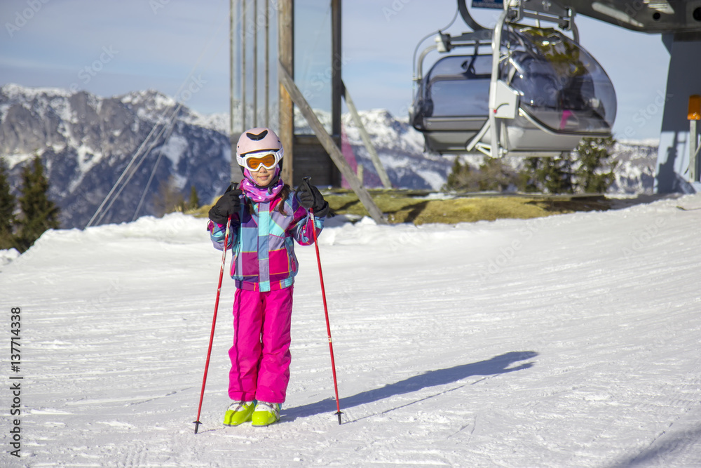 Girl on the mountain by the ski lift