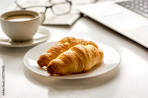 Office breakfast with laptop on white desk