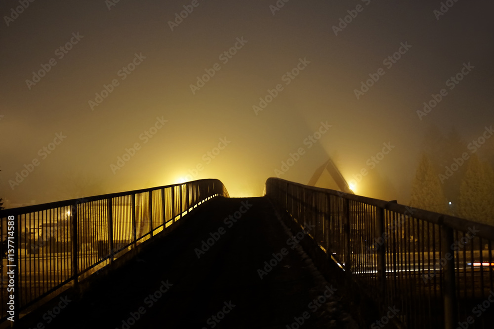 Lights shining through mist in the night over the bridge. Slovakia