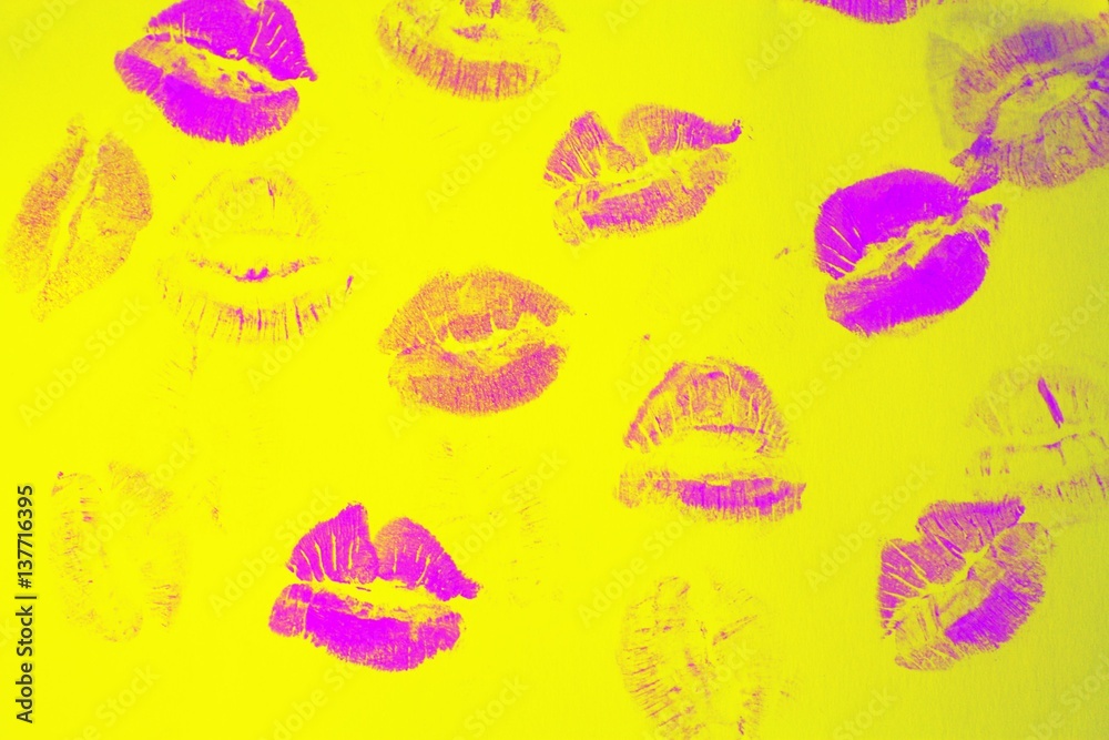 Naklejka premium Abstract purple lipstick kisses on yellow art background