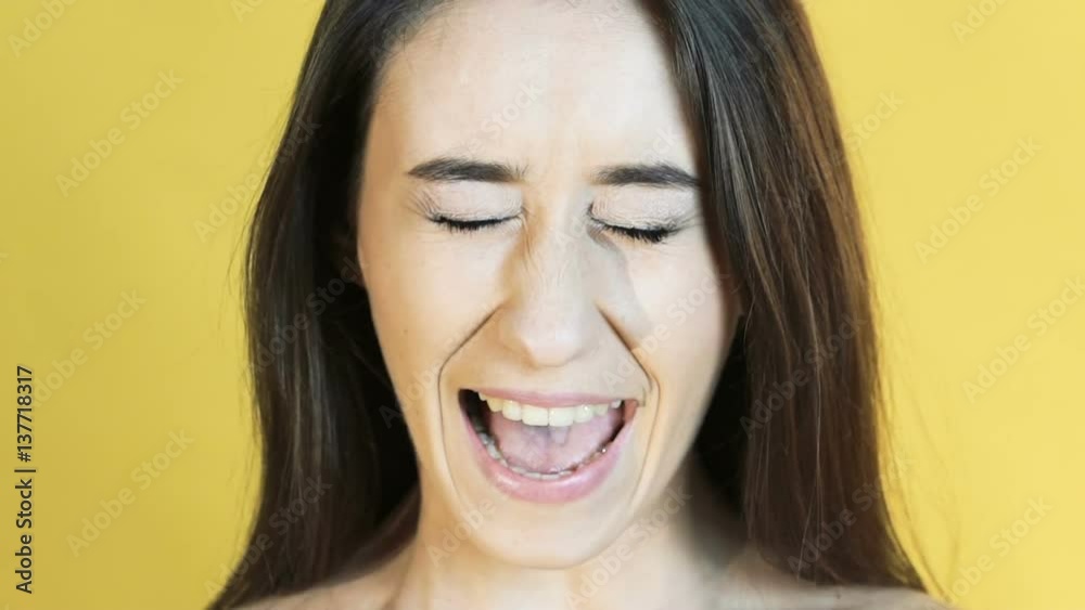 The girl crying on the yellow background. Slowly The girl crying on the yellow background. Slowly