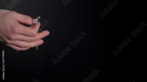 Car salesman handing over the keys for a new car to a young businessman on black background photo