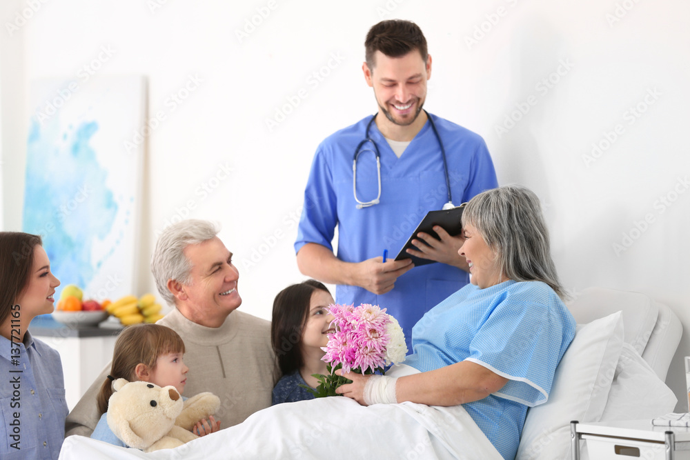 Fototapeta premium Family visiting grandmother in hospital