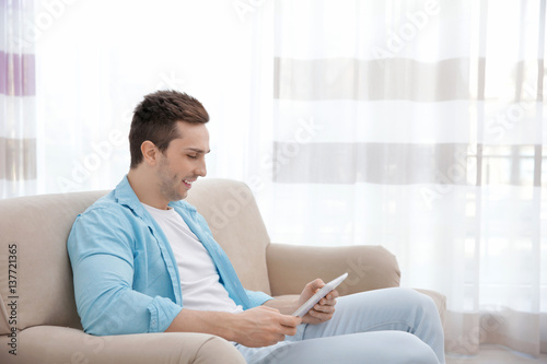 Young man resting on couch ...