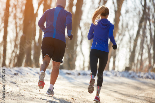 Runners couple running in park