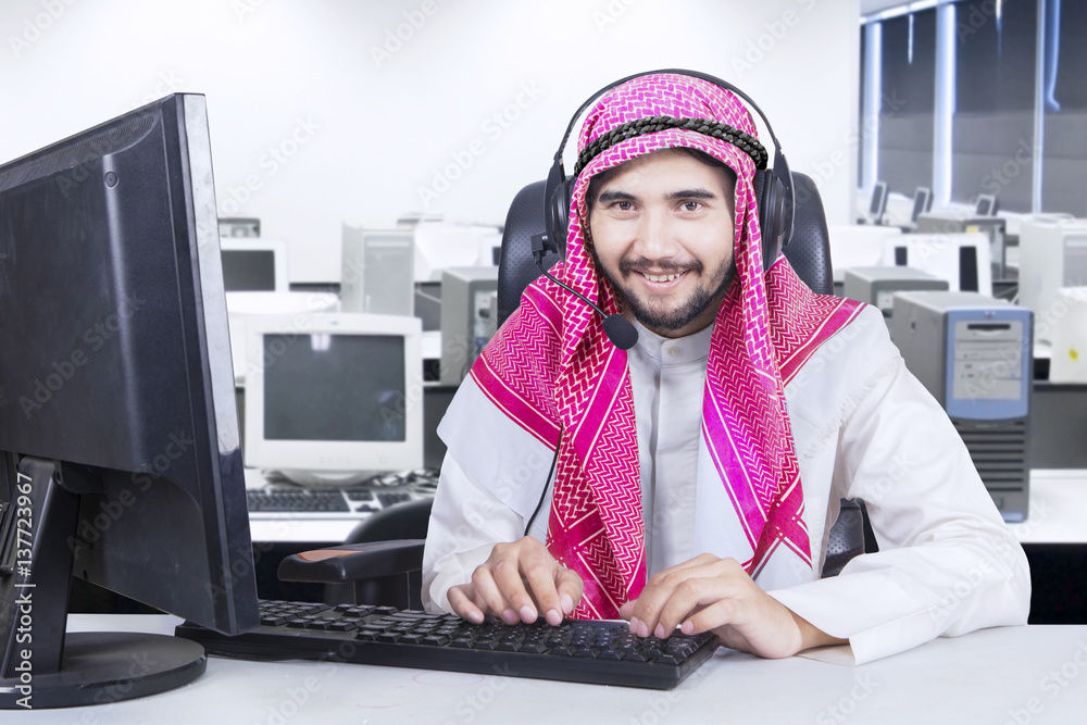 Male operator with computer and headphone Male operator with computer and headphone